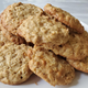 A pile of oatmeal scotchie cookies on a white plate
